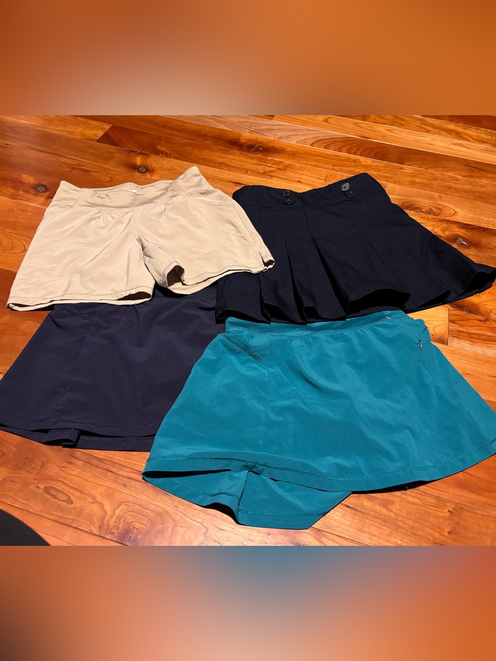 4 items. 2 Girls' Active Skorts in Teal & Navy, 1 Khaki shorts, 1 navy skirt